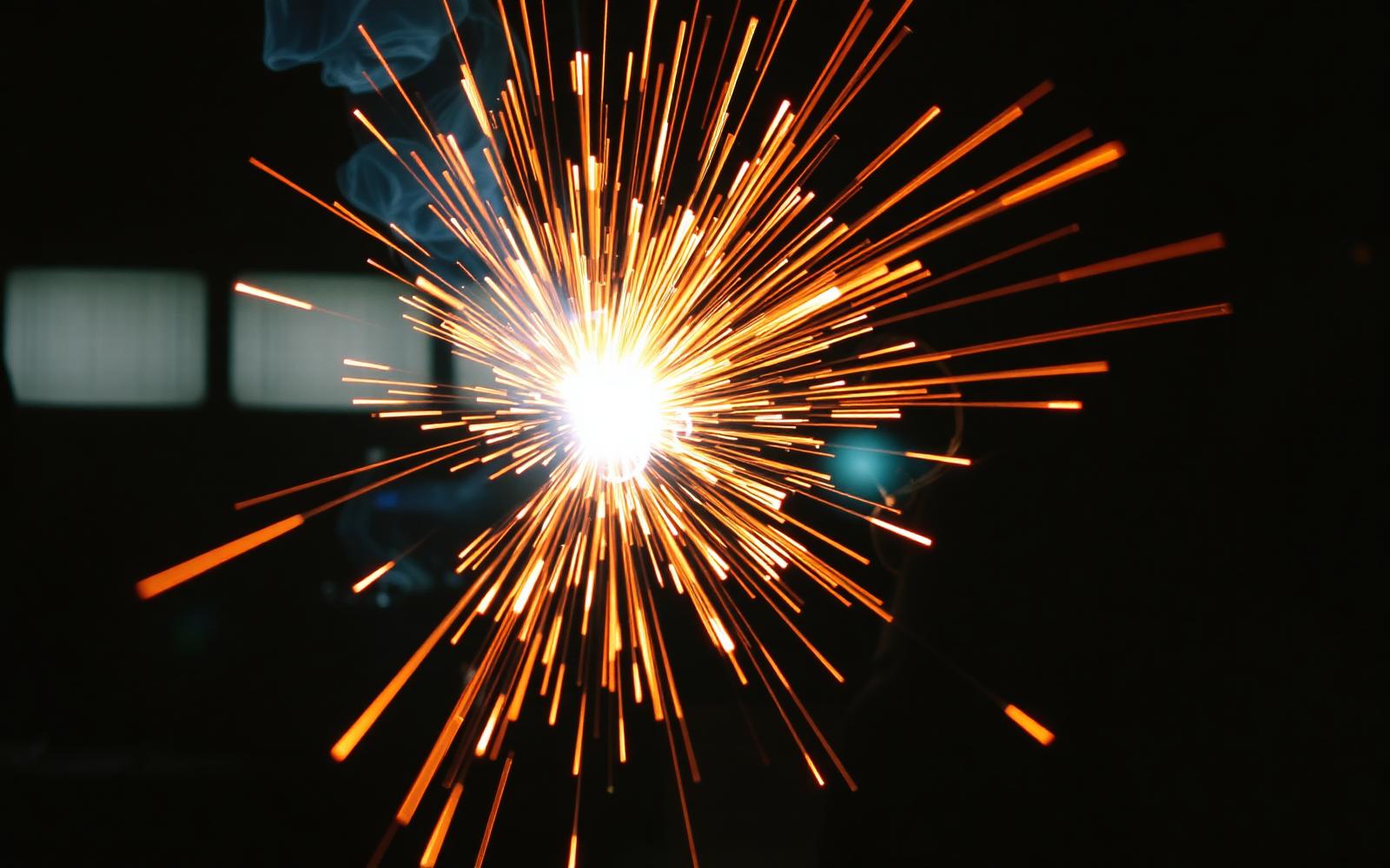 Welding sparks in a dark workshop